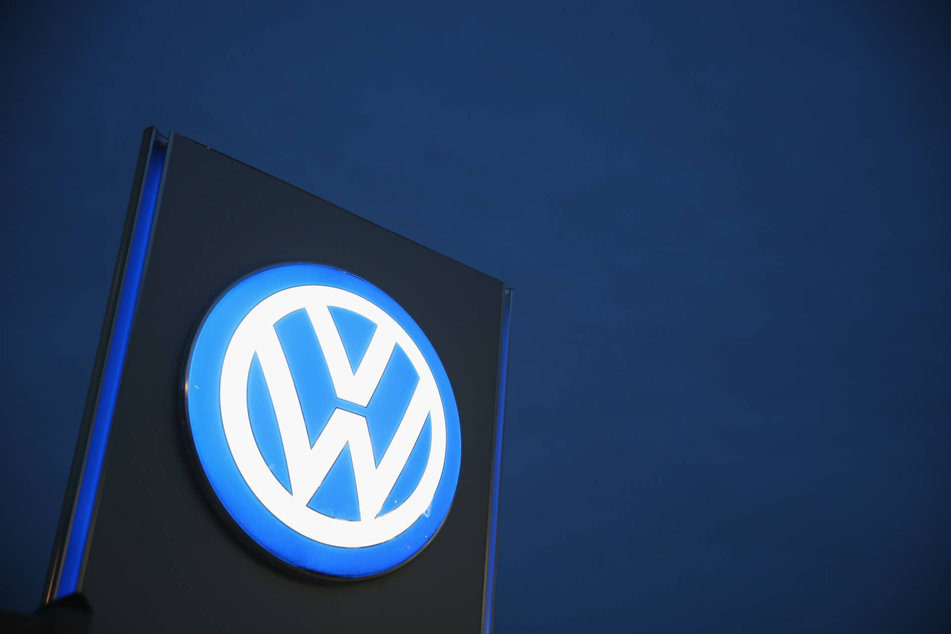 BERLIN, GERMANY - OCTOBER 06: The Volkswagen logo stands illuminated outside a VW dealership at night on October 6, 2015 in Berlin, Germany. Volkswagen has admitted that 8 million cars and light trucks in Europe alone are affected by the software the company deliberately installed in order to manipulate diesel emissions results under testing conditions. Since news of the issue broke two weeks ago Volkswagen's share price has dropped by over 40% and the company faces investigations and fines in countries across the globe. (Photo by Sean Gallup/Getty Images)