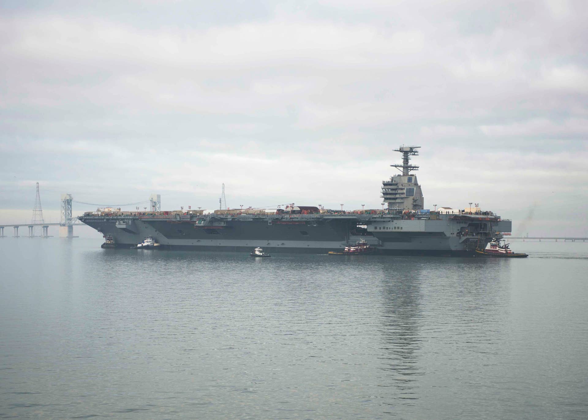 The aircraft carrier Pre-Commissioning Unit Gerald R. Ford (CVN 78) transits the James River during the ship's launch and transit to Newport News Shipyard pier three for the final stages of construction and testing. Ford was christened Nov. 9, 2013, and is under construction at Huntington Ingalls Industries Newport News Shipyard. (U.S. Navy photo by Mass Communication Specialist Second Class Aidan P. Campbell/Released)