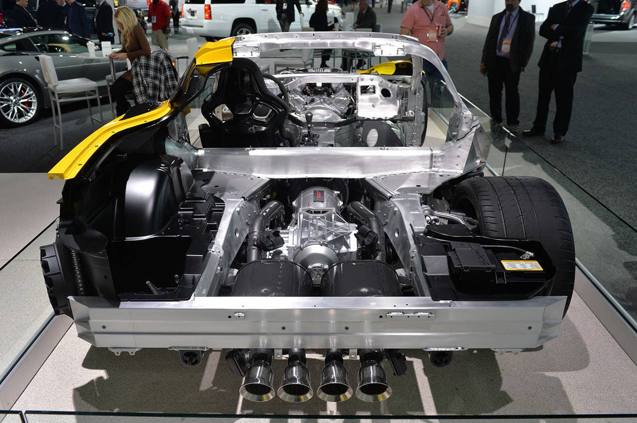 A square look at the rear of the new C7 Corvette Z06, with its quad-pipe exhaust and massive rear tires. The exhaust system's flappers, which control flow, are seen on the outboard pipes. Just outside that, mounted under the rear aluminum bumper, are the brackets for the exhaust hangers.