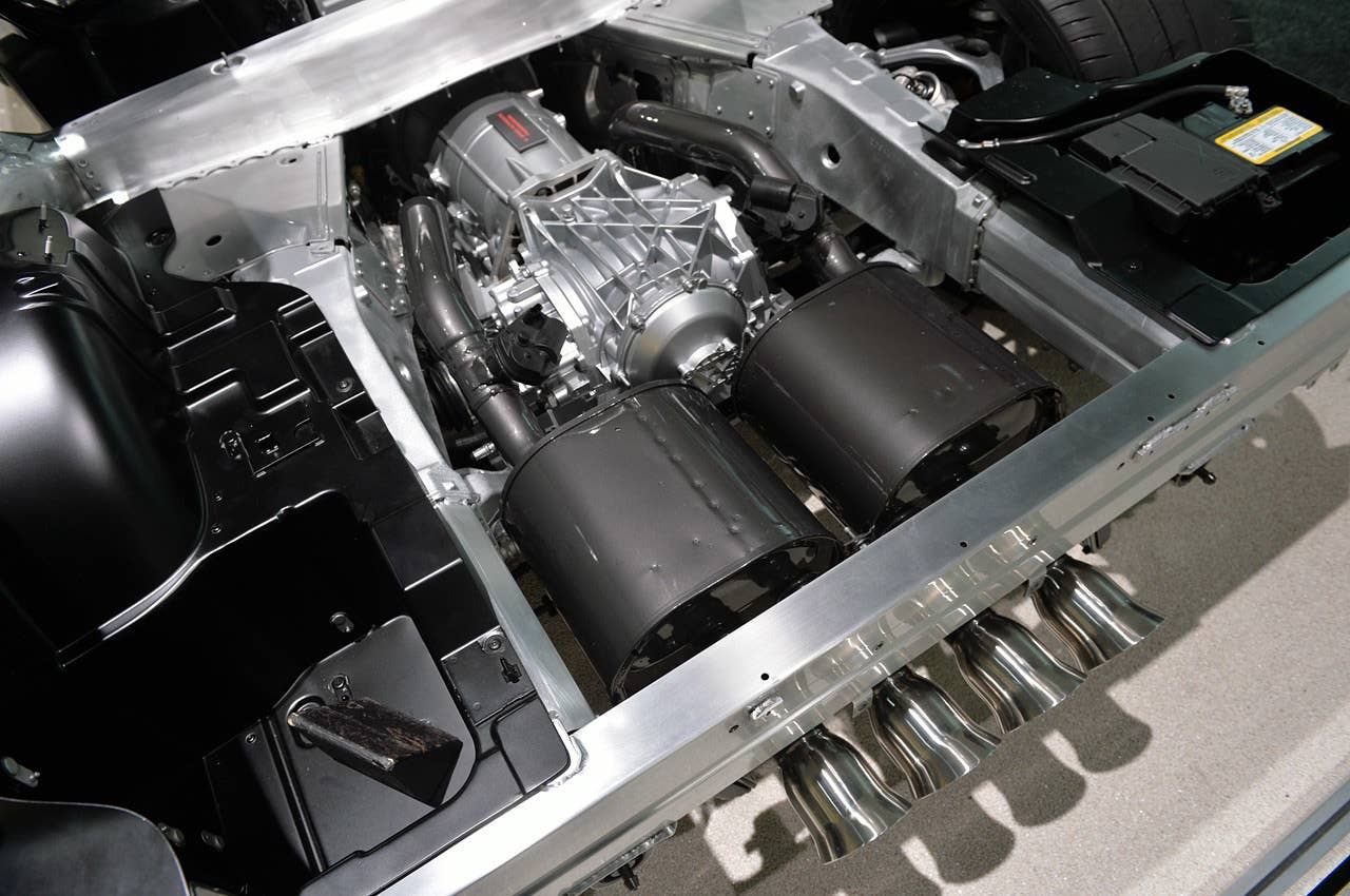 A nice shot of the quad exhaust tips coming off the steel mufflers (titanium was used on some C5 models, but its market price is too steep today). The aluminum beam at the bottom of the frame serves as the structural part of the rear bumper. Note the battery in the upper right corner, its weight being offset by the driver who sits on the left side of the chassis.