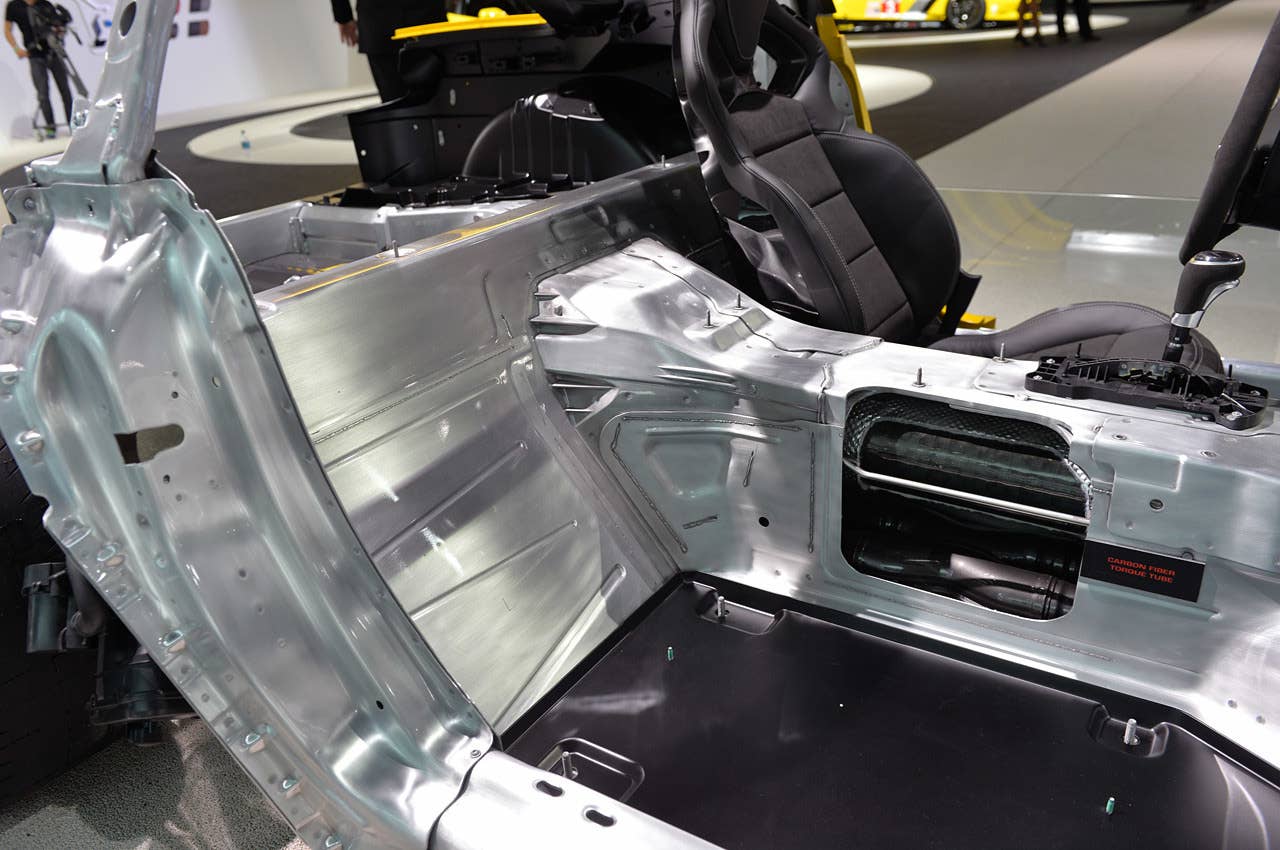 Looking at the chassis from the passenger side, without the seat installed. The extruded aluminum rails and firewall behind the passenger cabin are visible, as is the composite sandwich floor — there is no metal between the passengers and pavement! (Trivia: The new Boeing 787 uses a similar graphite-reinforced composite passenger cabin floor.)