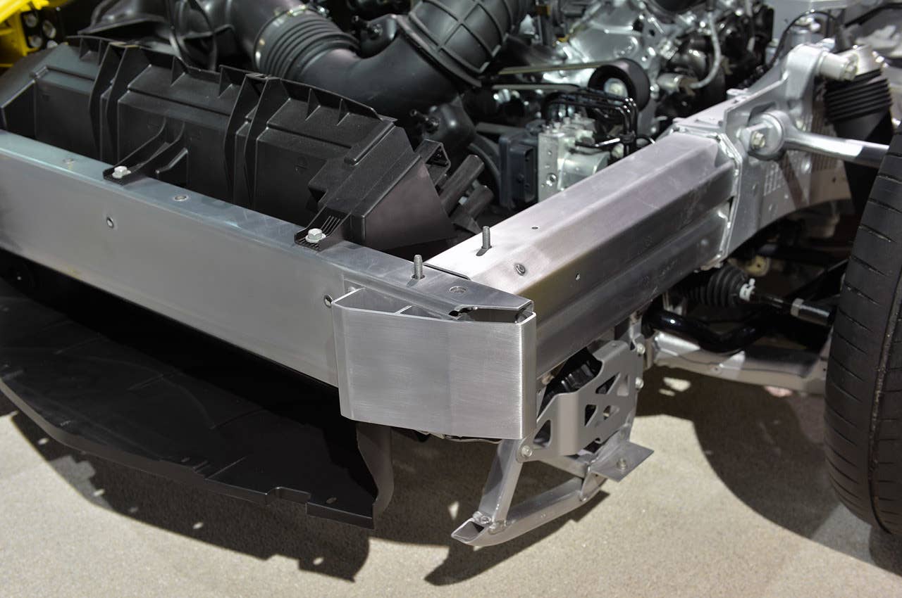This is the left front corner of the chassis, looking directly at the aluminum bumper reinforcement. Note the unique aluminum skid at the bottom, protecting the suspension and bottom of the engine. The plastic scoop, to the left of the image, feeds cold air into the engine's radiator.