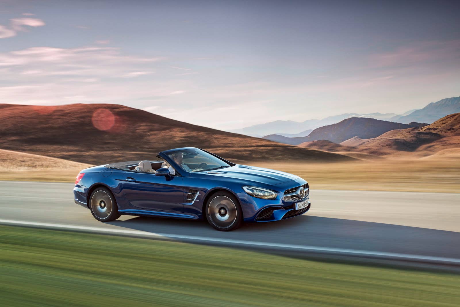 blue 2017 mercedes sl side mountains