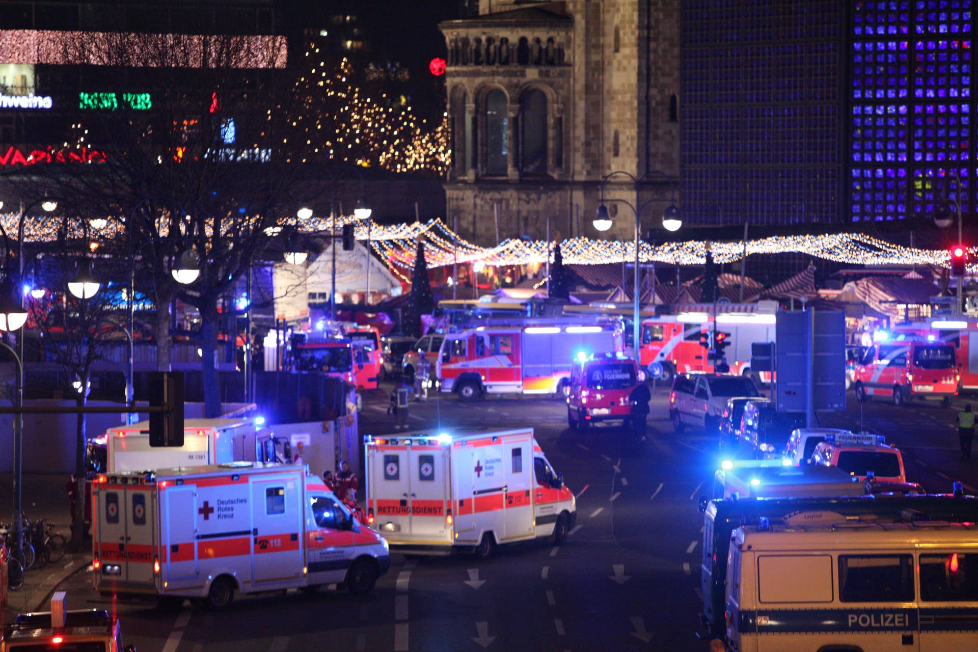 Ambulances are parked near the area after a lorry truck ploughed through a Christmas market on December 19, 2016 in Berlin, Germany. Several people have died while dozens have been injured as police investigate the attack at a market outside the Kaiser Wilhelm Memorial Church on the Kurfuerstendamm and whether it is linked to a terrorist plot.(Photo by Omer Messinger/NurPhoto via Getty Images)