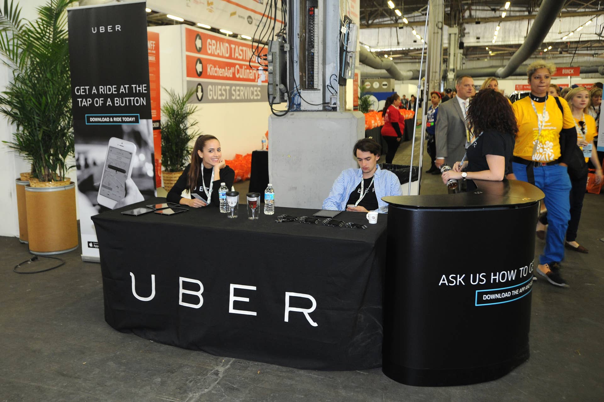 NEW YORK, NY - OCTOBER 18: A general view of atmosphere at the Uber Technologies station at the Grand Tasting presented by ShopRite featuring KitchenAidÂ® culinary demonstrations presented by MasterCard during the Food Network New York City Wine & Food Festival Presented By FOOD & WINE at Pier 94 on October 18, 2014 in New York City.  (Photo by Bryan Bedder/Getty Images for NYCWFF)
