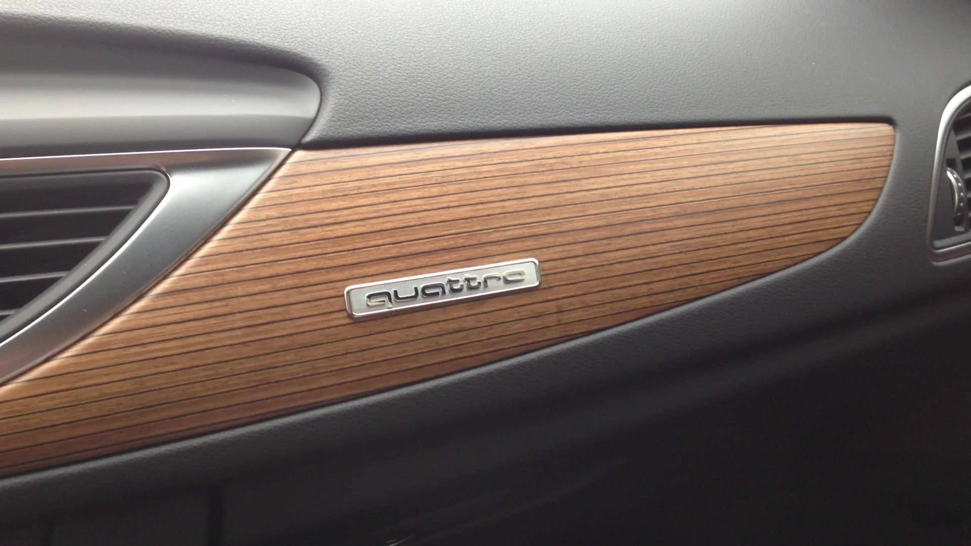 Senior editor Greg Migliore shows off the wood trim inside the 2016 Audi A6.