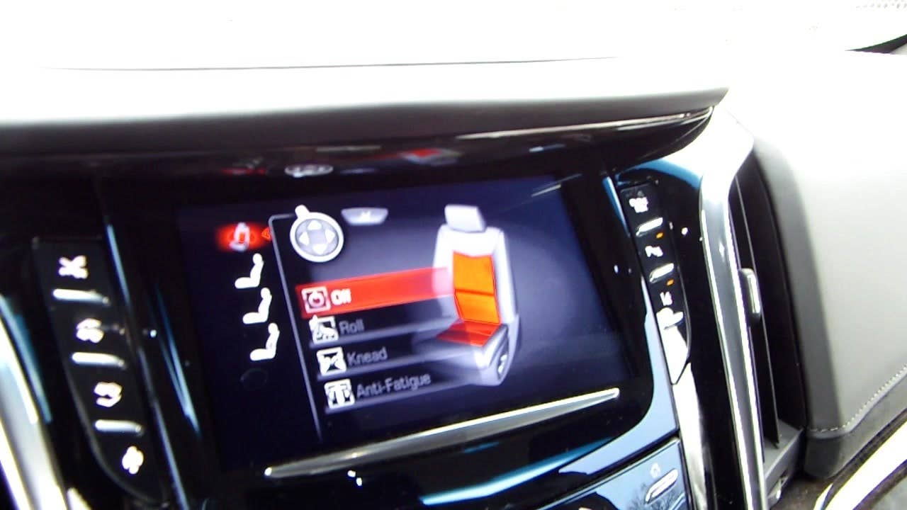 Autoblog's Jeremy Korzeniewski demonstrates the massaging seats of the 2015 Cadillac Escalade Platinum.