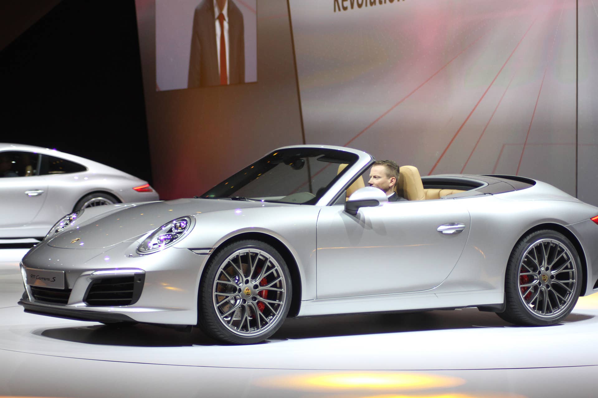 The 2016 Porsche 911 Carrera S Cabriolet, now with a turbocharged engine in the standard car, unveiled at Volkswagen's Group Night ahead of the 2015 Frankfurt Motor Show, near front three-quarter view.