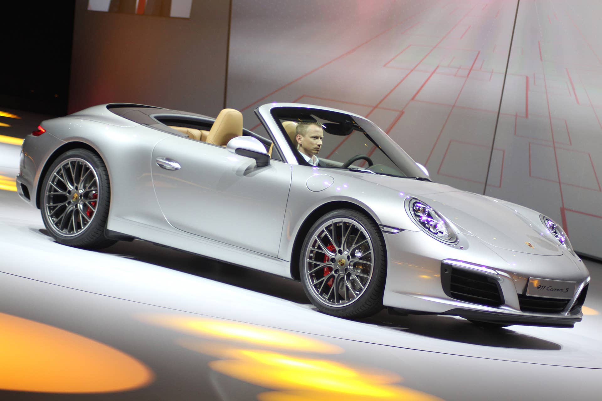 The 2016 Porsche 911 Carrera S Cabriolet, now with a turbocharged engine in the standard car, unveiled at Volkswagen's Group Night ahead of the 2015 Frankfurt Motor Show, front three-quarter view.