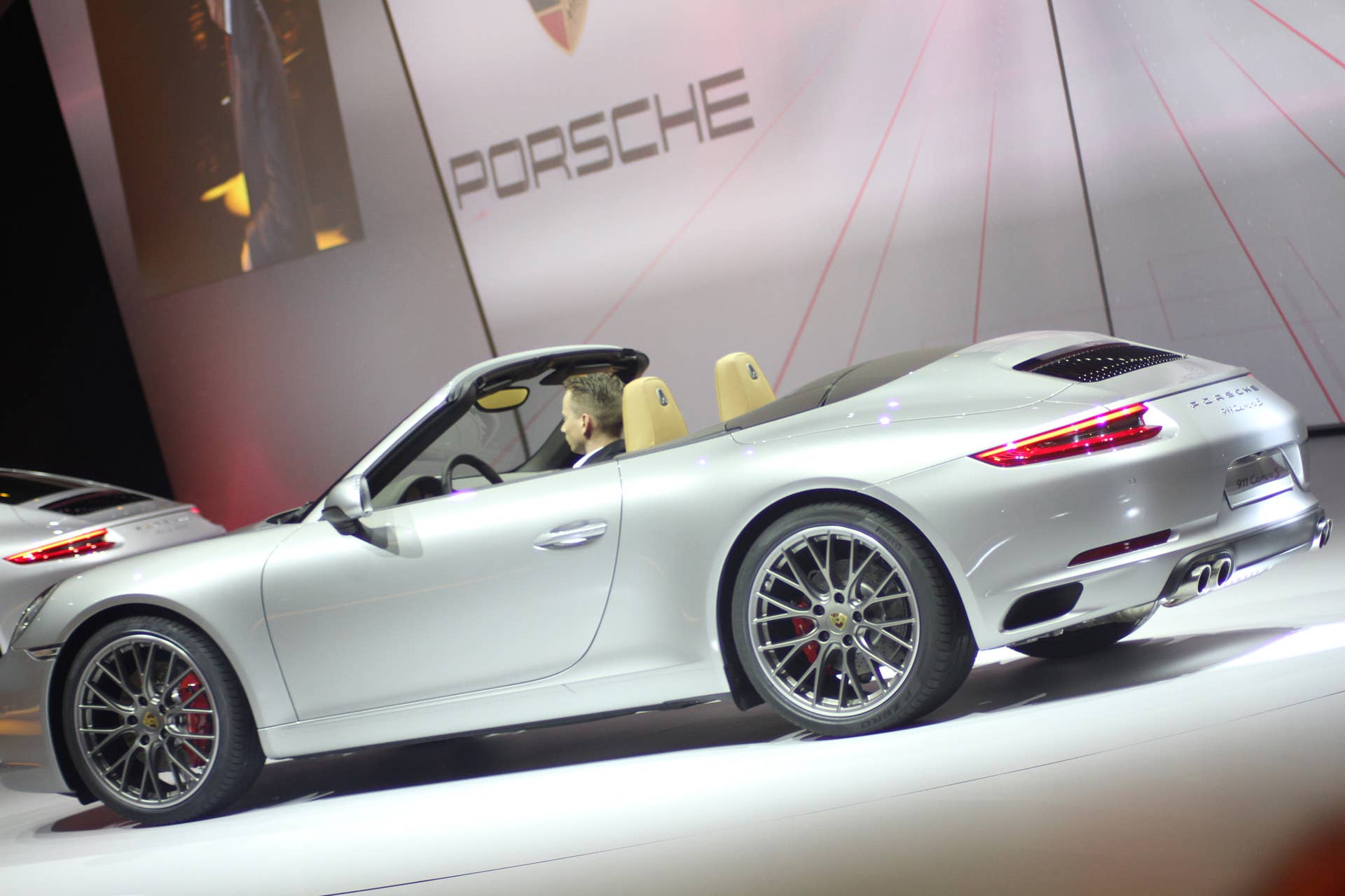 The 2016 Porsche 911 Carrera S Cabriolet, now with a turbocharged engine in the standard car, unveiled at Volkswagen's Group Night ahead of the 2015 Frankfurt Motor Show, rear three-quarter view.