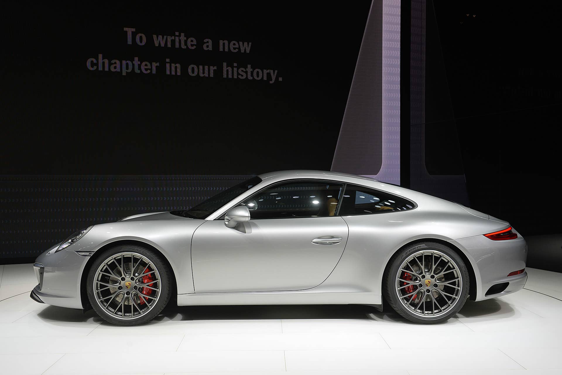 The 2016 Porsche 911 Carrera, now with a turbocharged engine in the standard car, unveiled at the Frankfurt Motor Show, side view.