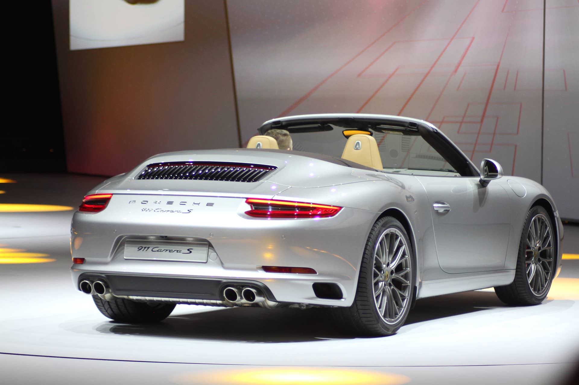 The 2016 Porsche 911 Carrera S Cabriolet, now with a turbocharged engine in the standard car, unveiled at Volkswagen's Group Night ahead of the 2015 Frankfurt Motor Show, rear three-quarter view.