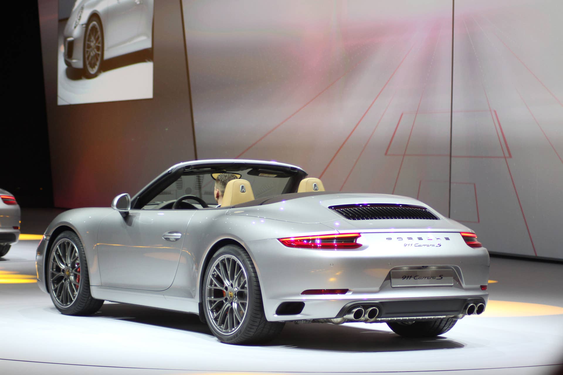 The 2016 Porsche 911 Carrera S Cabriolet, now with a turbocharged engine in the standard car, unveiled at Volkswagen's Group Night ahead of the 2015 Frankfurt Motor Show, rear three-quarter view.