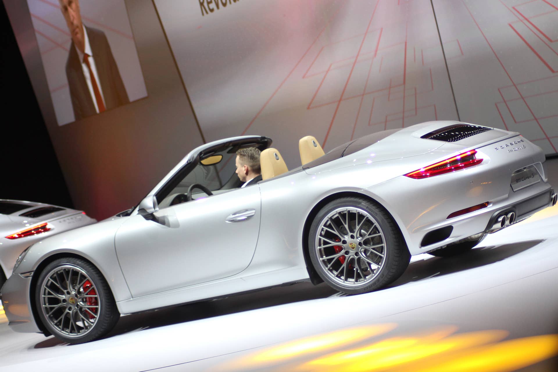 The 2016 Porsche 911 Carrera S Cabriolet, now with a turbocharged engine in the standard car, unveiled at Volkswagen's Group Night ahead of the 2015 Frankfurt Motor Show, rear three-quarter view.