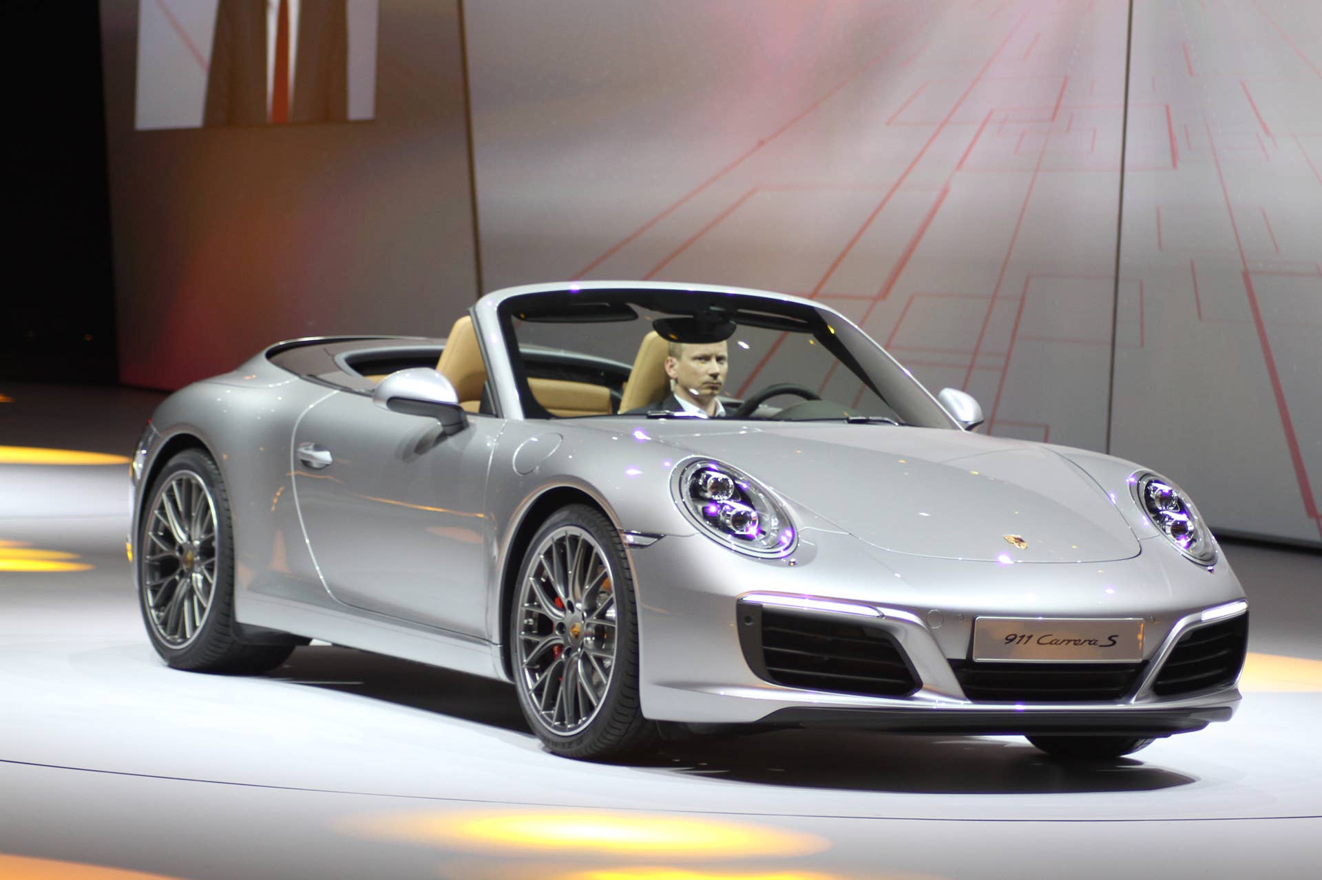 The 2016 Porsche 911 Carrera S Cabriolet, now with a turbocharged engine in the standard car, unveiled at Volkswagen's Group Night ahead of the 2015 Frankfurt Motor Show, front three-quarter view.
