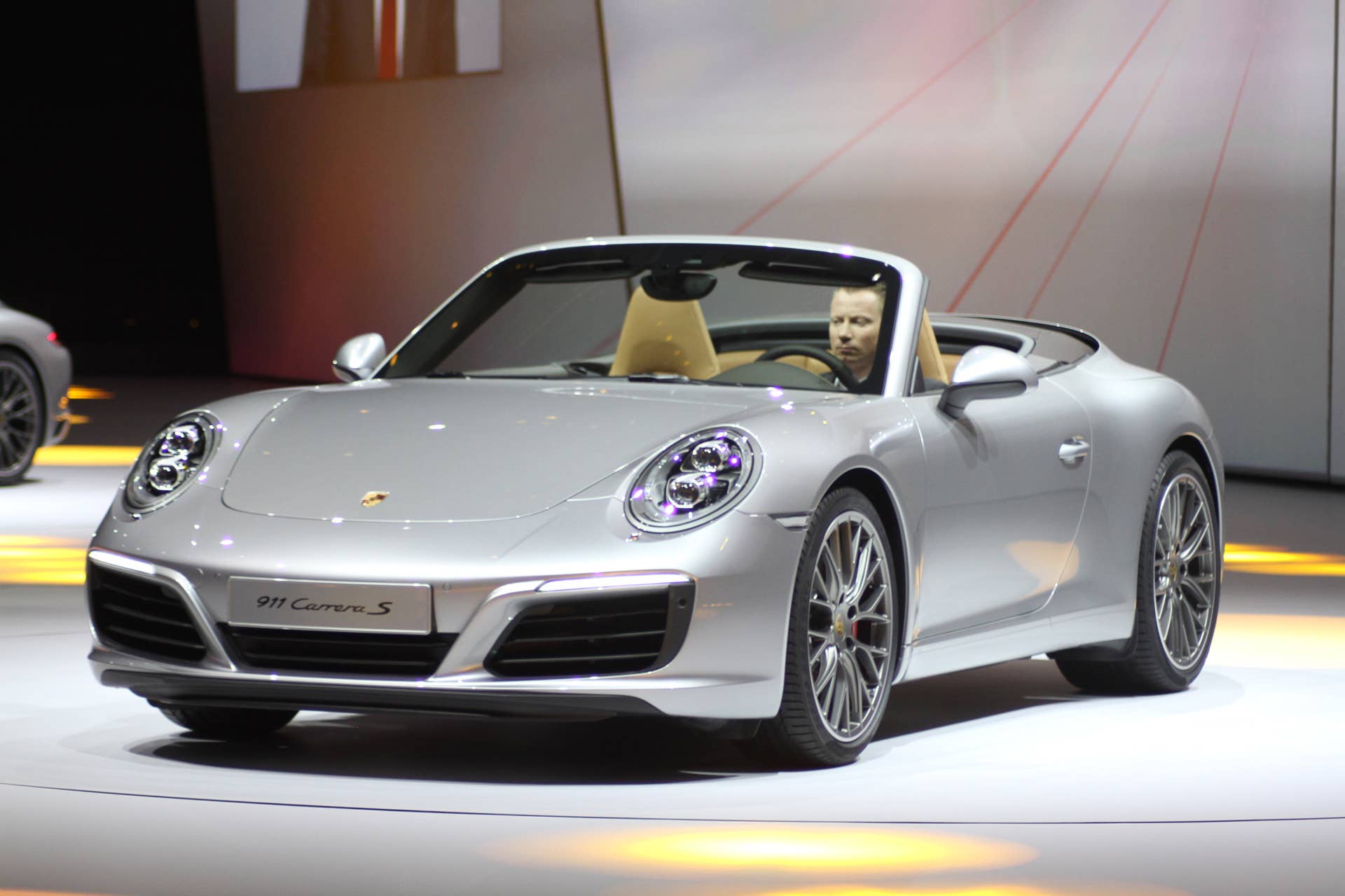 The 2016 Porsche 911 Carrera S Cabriolet, now with a turbocharged engine in the standard car, unveiled at Volkswagen's Group Night ahead of the 2015 Frankfurt Motor Show, front three-quarter view.