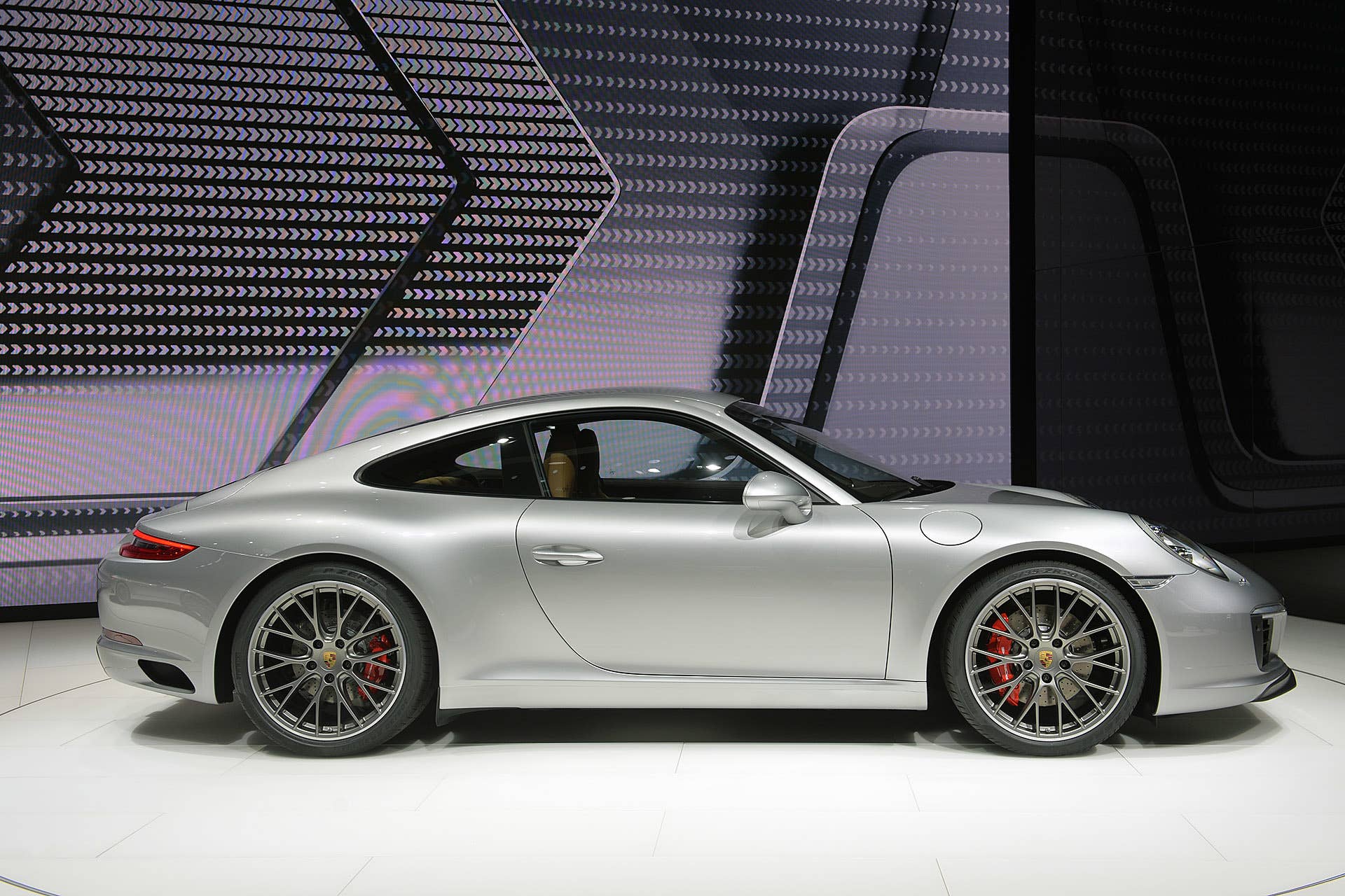The 2016 Porsche 911 Carrera, now with a turbocharged engine in the standard car, unveiled at the Frankfurt Motor Show, side view.