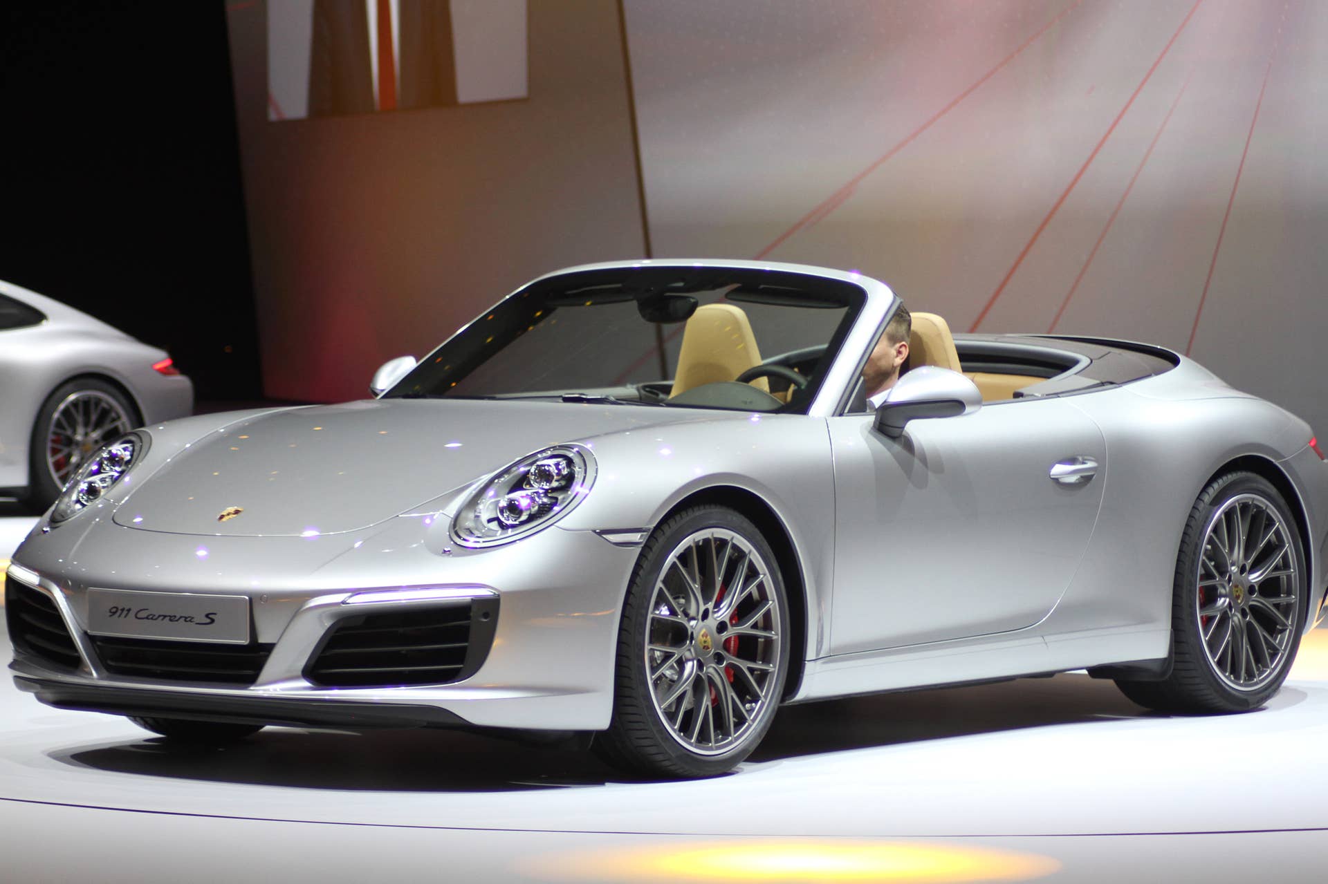 The 2016 Porsche 911 Carrera S Cabriolet, now with a turbocharged engine in the standard car, unveiled at Volkswagen's Group Night ahead of the 2015 Frankfurt Motor Show, front three-quarter view.