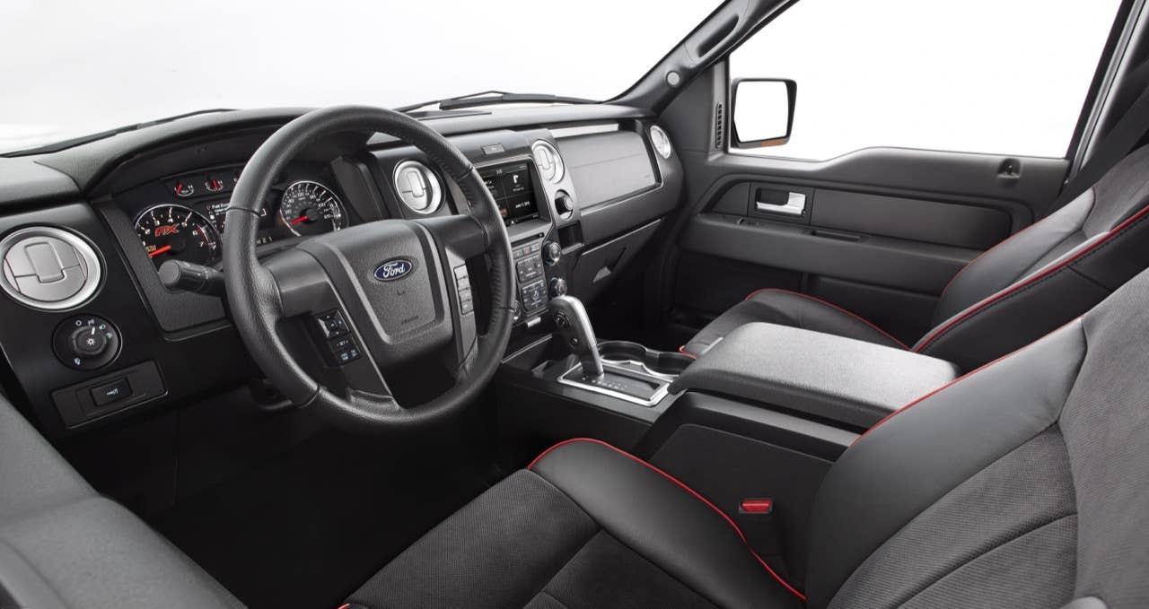 2014 Ford F-150 Tremor: Customized interior touches include black leather seating surfaces with red trim, brushed-metal accents and a red-stitched steering wheel. Alcantara seat inserts add color and styling as well. (06/27/2013)