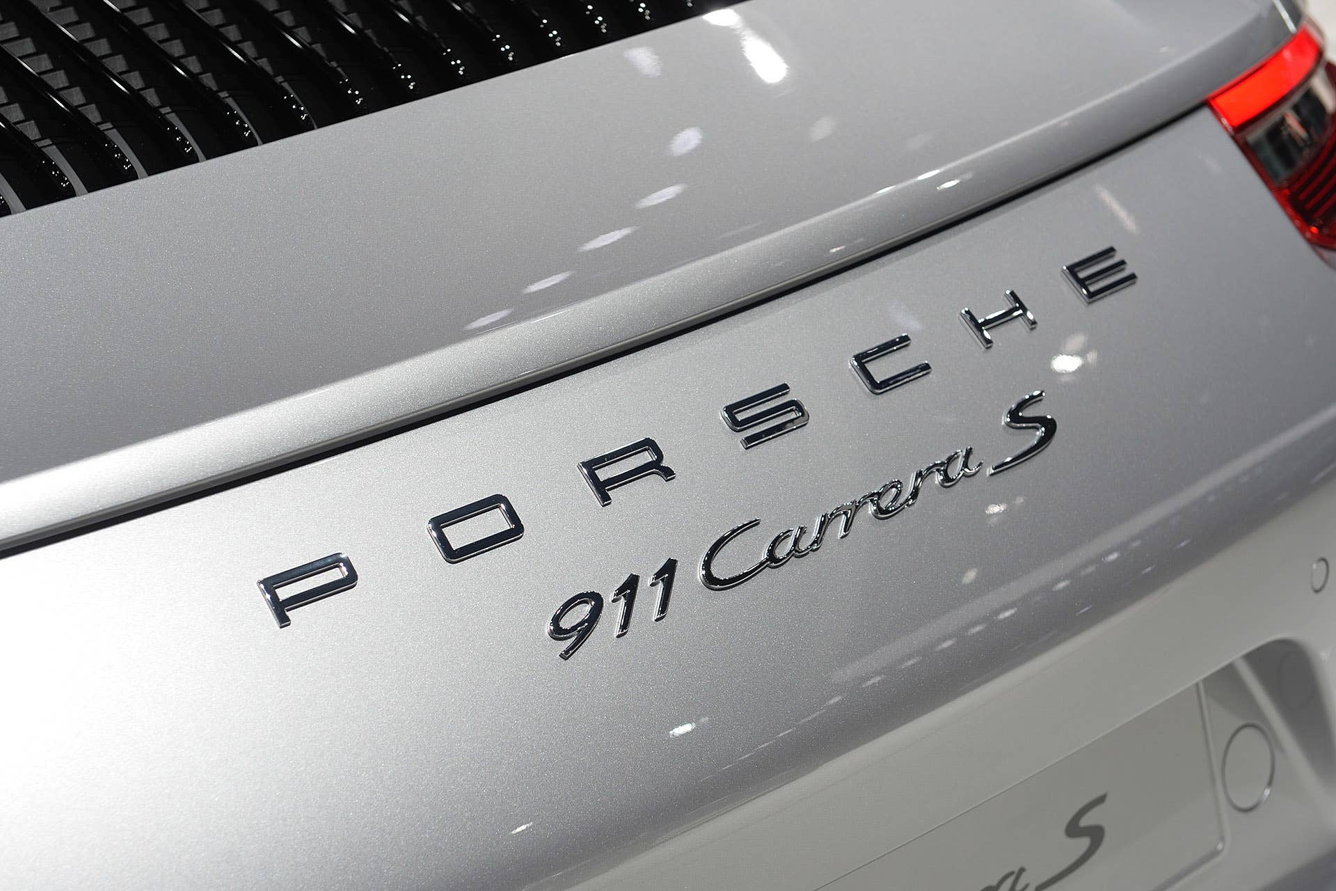 The 2016 Porsche 911 Carrera, now with a turbocharged engine in the standard car, unveiled at the Frankfurt Motor Show, hood cover badge detail.