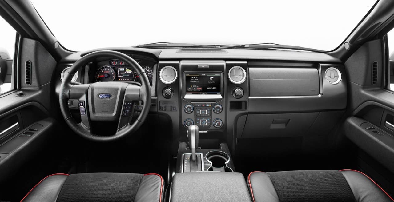 2014 Ford F-150 Tremor: Customized interior touches include black leather seating surfaces with red trim, brushed-metal accents and a red-stitched steering wheel. Alcantara seat inserts add color and styling as well. (06/27/2013)