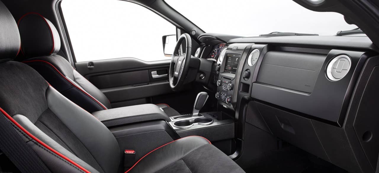 2014 Ford F-150 Tremor: Customized interior touches include black leather seating surfaces with red trim, brushed-metal accents and a red-stitched steering wheel. Alcantara seat inserts add color and styling as well. (06/27/2013)