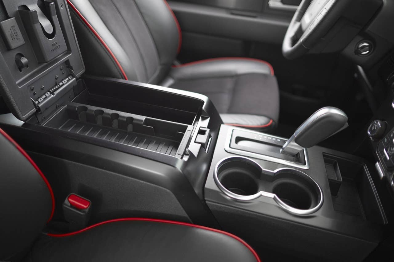 2014 Ford F-150 Tremor: Customized interior touches include black leather seating surfaces with red trim, brushed-metal accents and a red-stitched steering wheel. Alcantara seat inserts add color and styling as well. (06/27/2013)