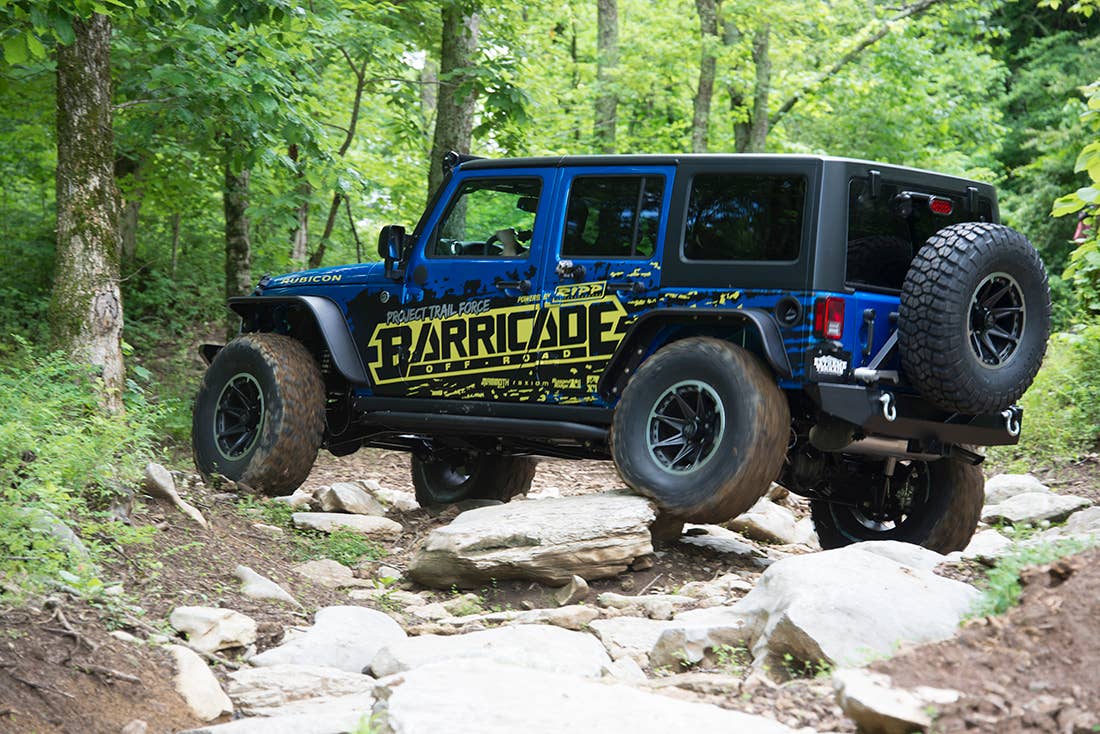 Project Trail Force 2015 Jeep Wrangler Rubicon traversing rocks.