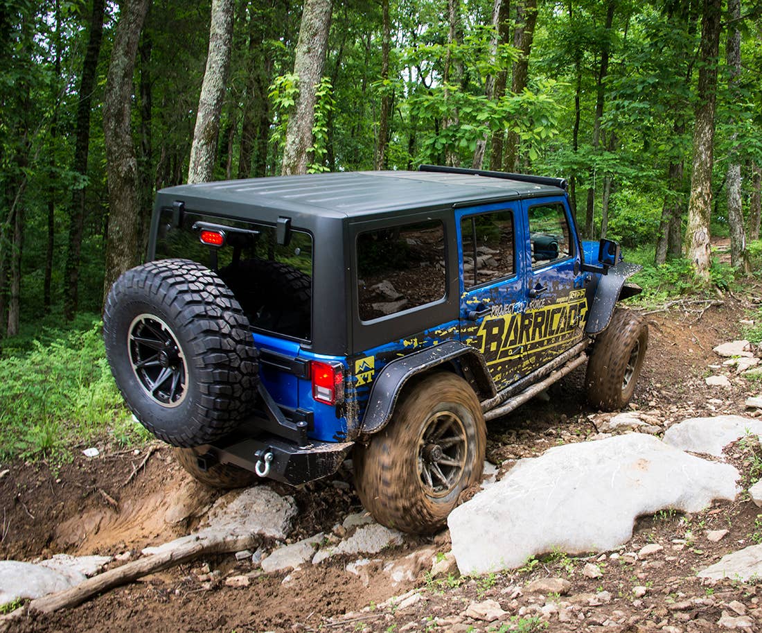 Project Trail Force 2015 Jeep Wrangler Rubicon climbing a trail.