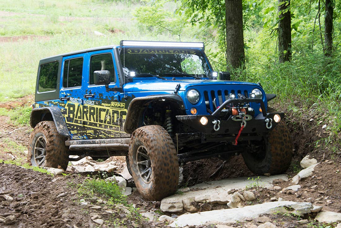 Project Trail Force 2015 Jeep Wrangler Rubicon navigating a trail.