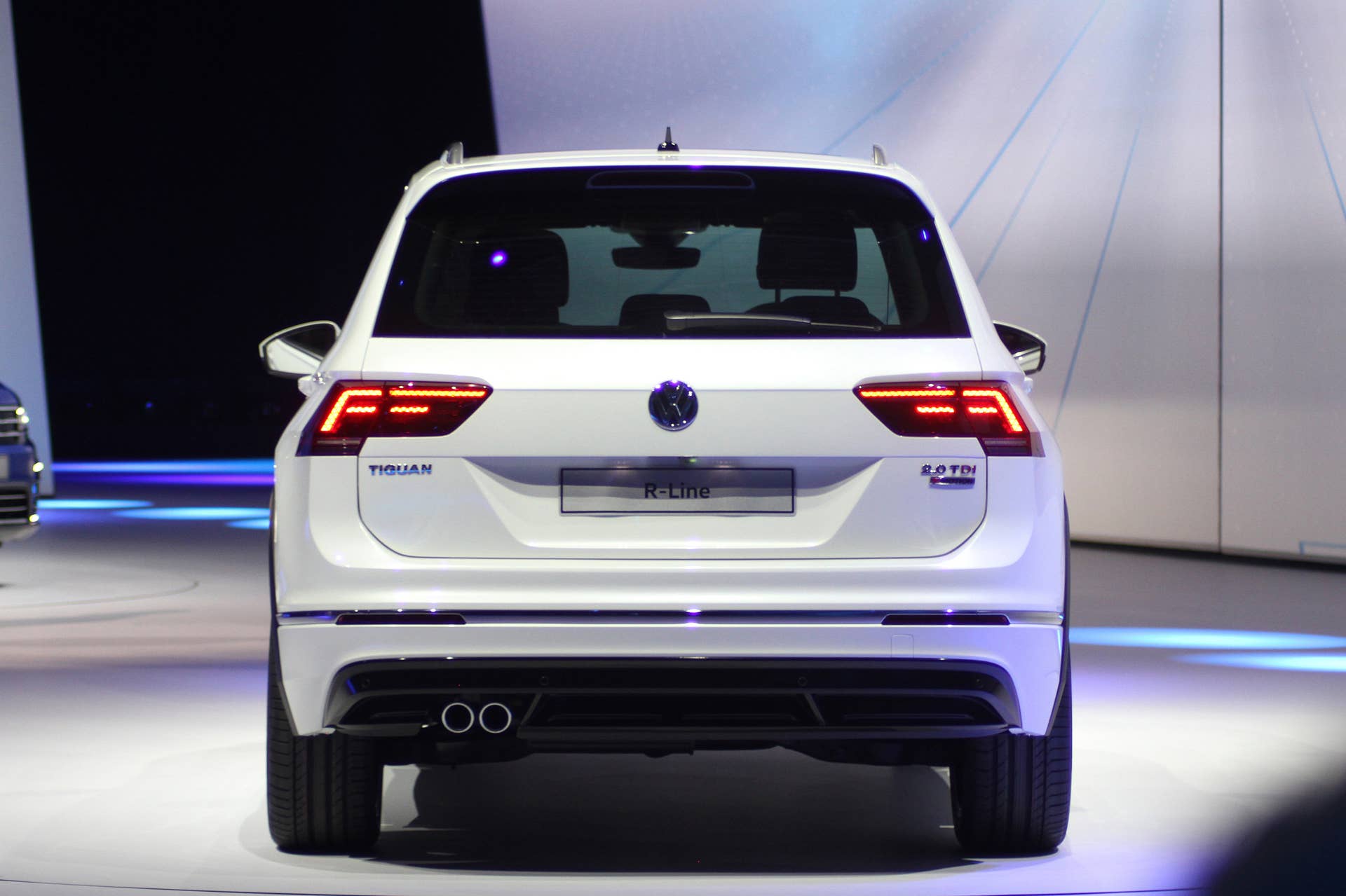 The 2016 Volkswagen Tiguan R-Line, unveiled at Volkswagen's Group Night ahead of the 2015 Frankfurt Motor Show, rear view with taillights on.