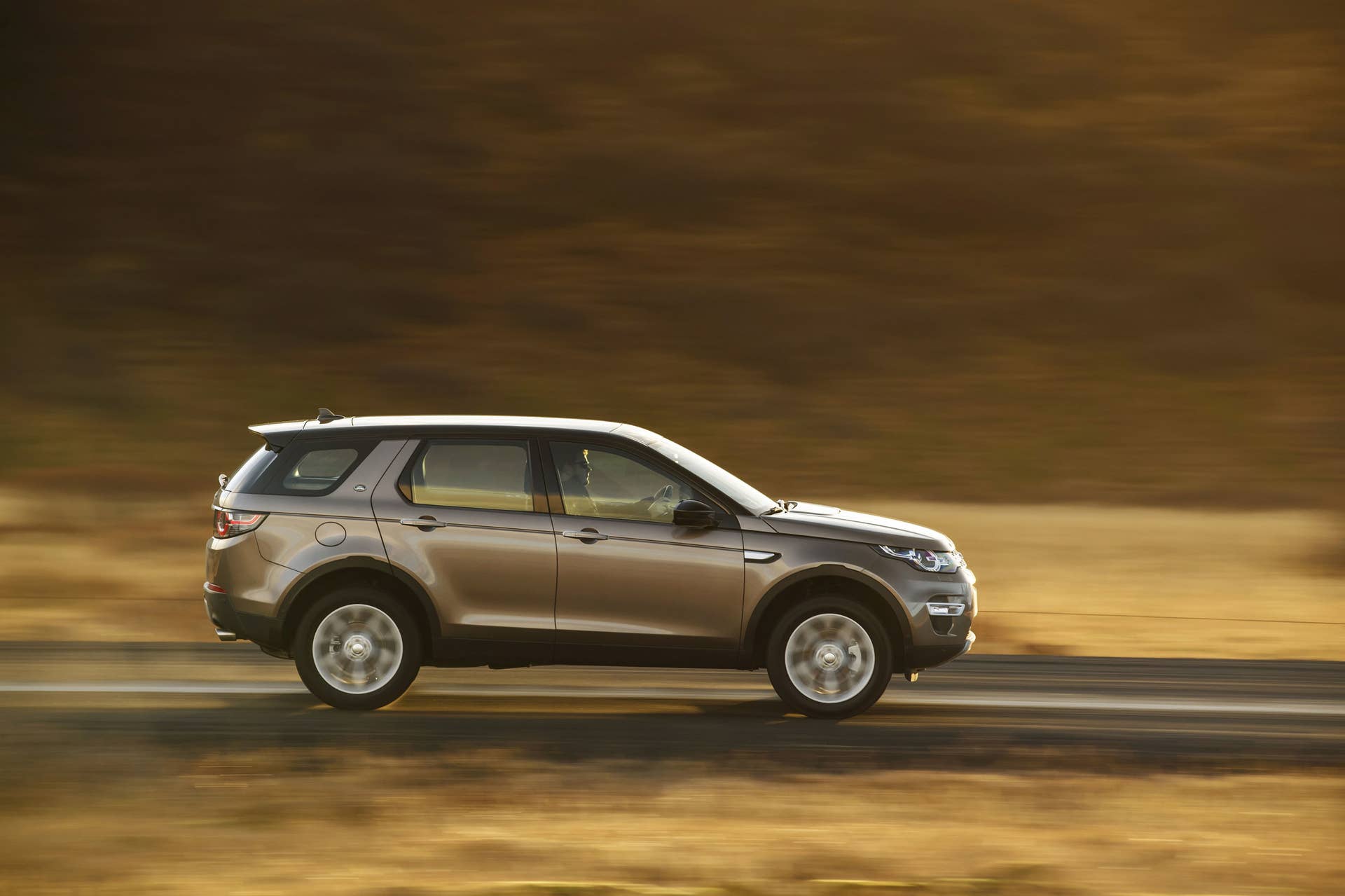 Land Rover Discovery Sport Ingenium diesel moving road side brown