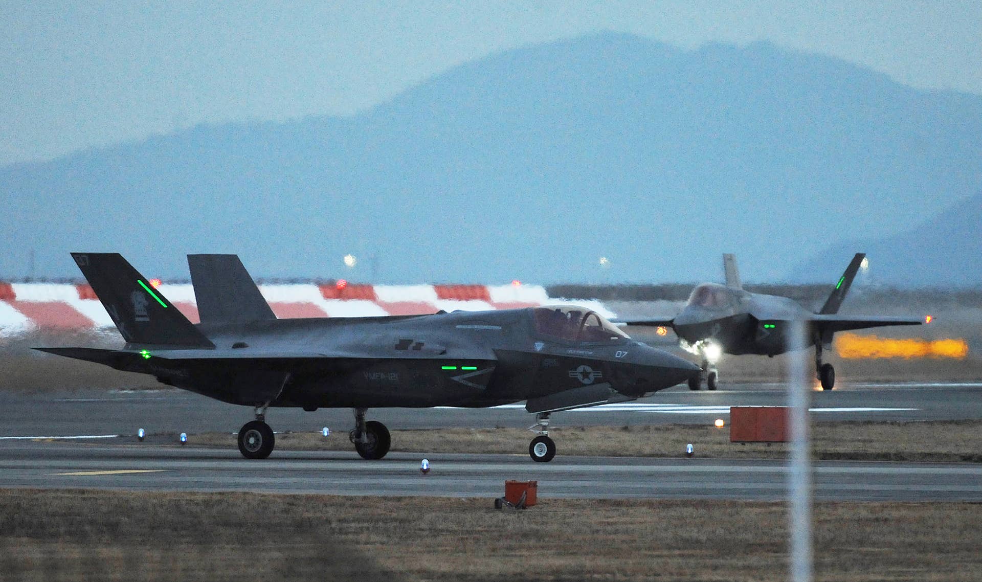 This picture taken on January 18, 2017 shows two US F-35B stealth fighter jet taxiing after landing at the US Marine's Iwakuni Air Station in Iwakuni, Yamaguchi prefecture. The US Marine Corps said on January 11 it was sending a squadron of F-35B fighter jets to Japan, marking the first operational overseas deployment for the controversial aircraft that is under scrutiny from President-elect Donald Trump. / AFP / JIJI PRESS / JIJI PRESS / Japan OUT (Photo credit should read JIJI PRESS/AFP/Getty Images)