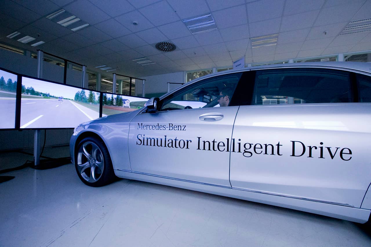 The Intelligent Drive simulator using an S-Class placed in front of six screens.