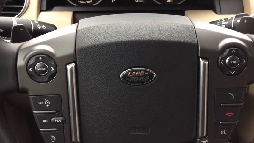 Greg Migliore shows off the steering wheel features of the 2015 Land Rover LR4.