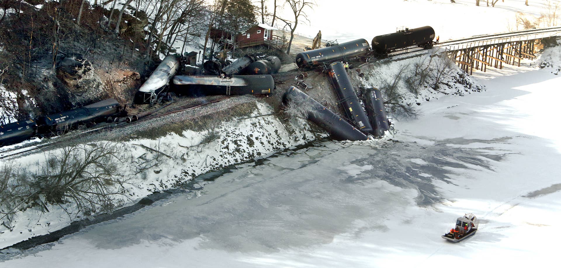 Crews work at the scene of a Canadian Pacific freight train derailment north of Dubuque, Iowa, Thursday, Feb. 5, 2015. Three railcars plunged into the river, and eight leaked ethanol after the derailment Wednesday. Railroad officials said Thursday it's unclear how much ethanol has leaked into the Mississippi River from the train, but that they were working to monitor the environmental impact and offload fuel from the train. (AP/Telegraph Herald, Dave Kettering)