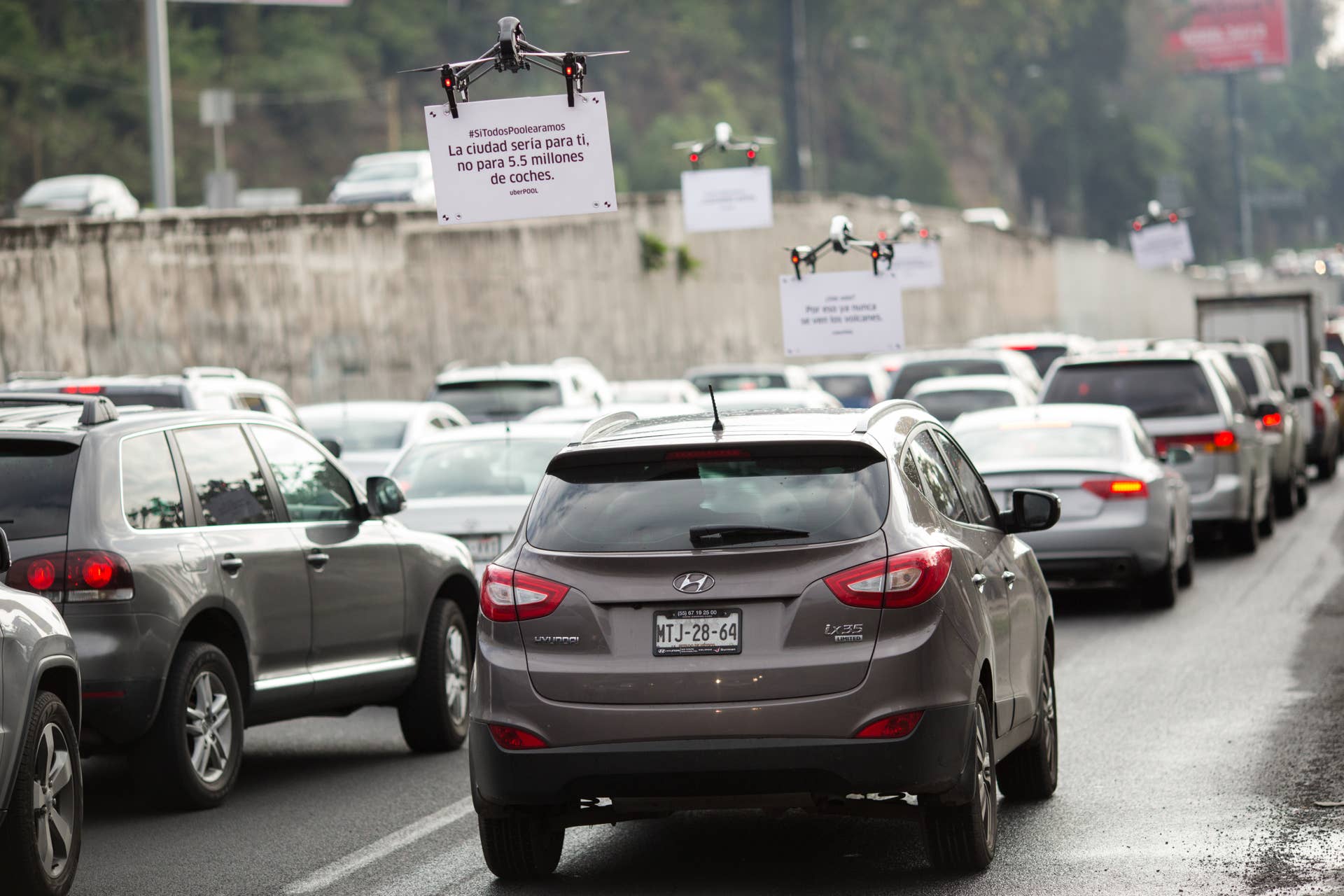 Uber Technologies Inc. drones advertise uberPOOL above traffic on a highway in Mexico City, Mexico, on Friday, June 17, 2016. The air quality in Mexico City has risen above the government's acceptable limits triggering restrictions on automobile usage and stricter vehicle emissions testing. Photographer: Brett Gundlock/Bloomberg via Getty Images