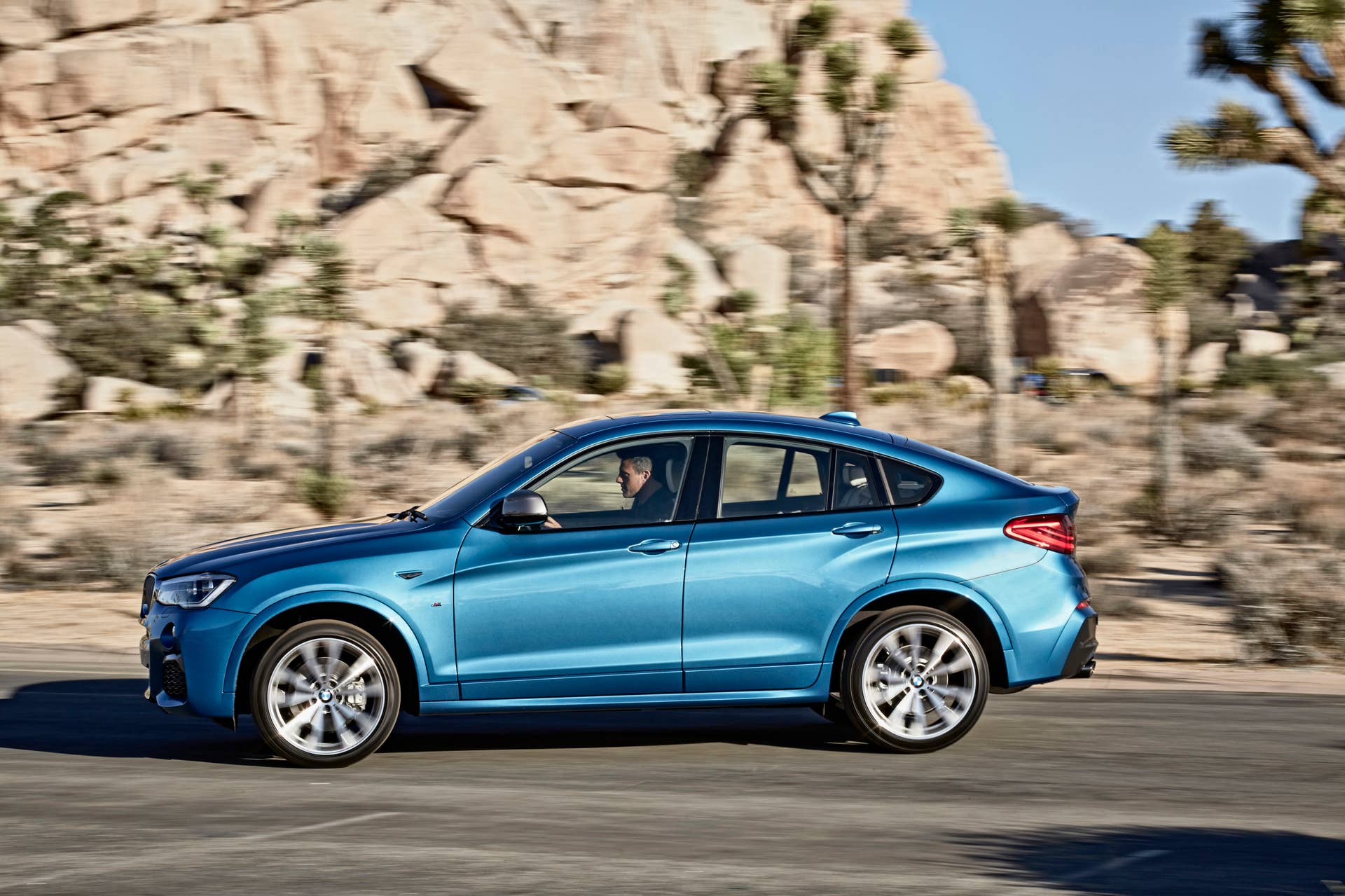 BMW X4 M40i front 3/4 moving road location
