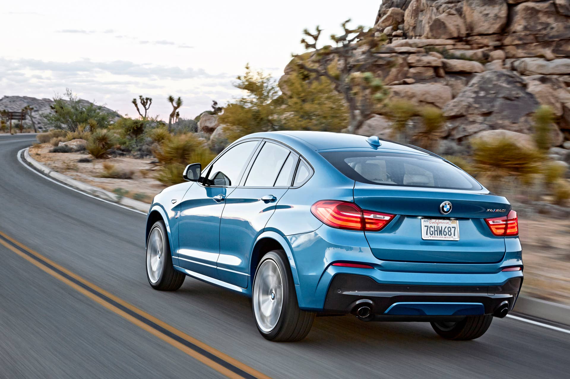 BMW X4 M40i rear 3/4 view road