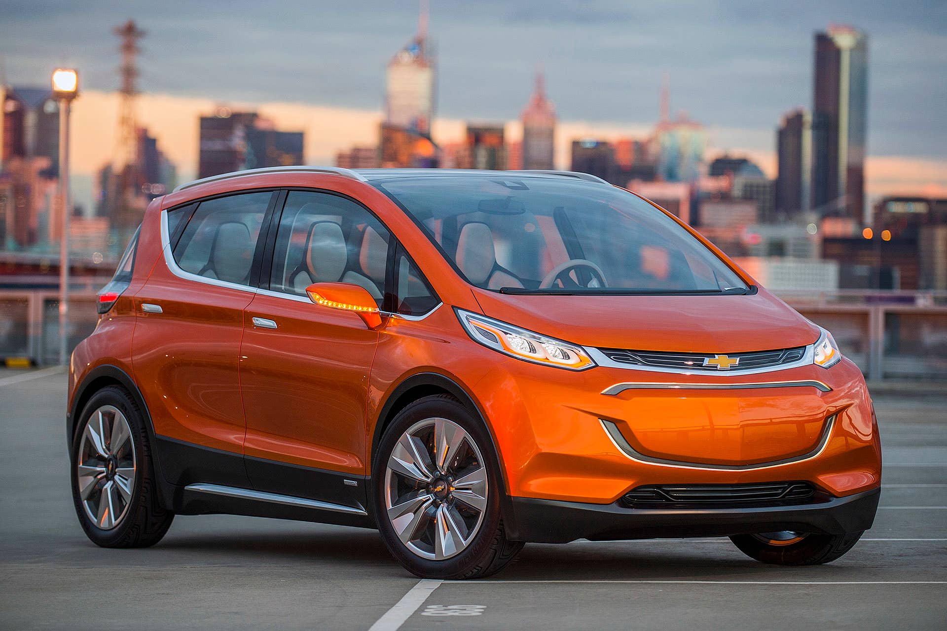 2015 Chevrolet Bolt EV Concept all electric vehicle. Front ¾ in city scape. Bolt EV Concept builds upon Chevyâs experience gained from both the Volt and Spark EV to make an affordable, long-range all-electric vehicle to market. The Bolt EV is designed to meet the daily driving needs of Chevrolet customers around the globe with more than 200 miles of range and a price tag around $30,000.