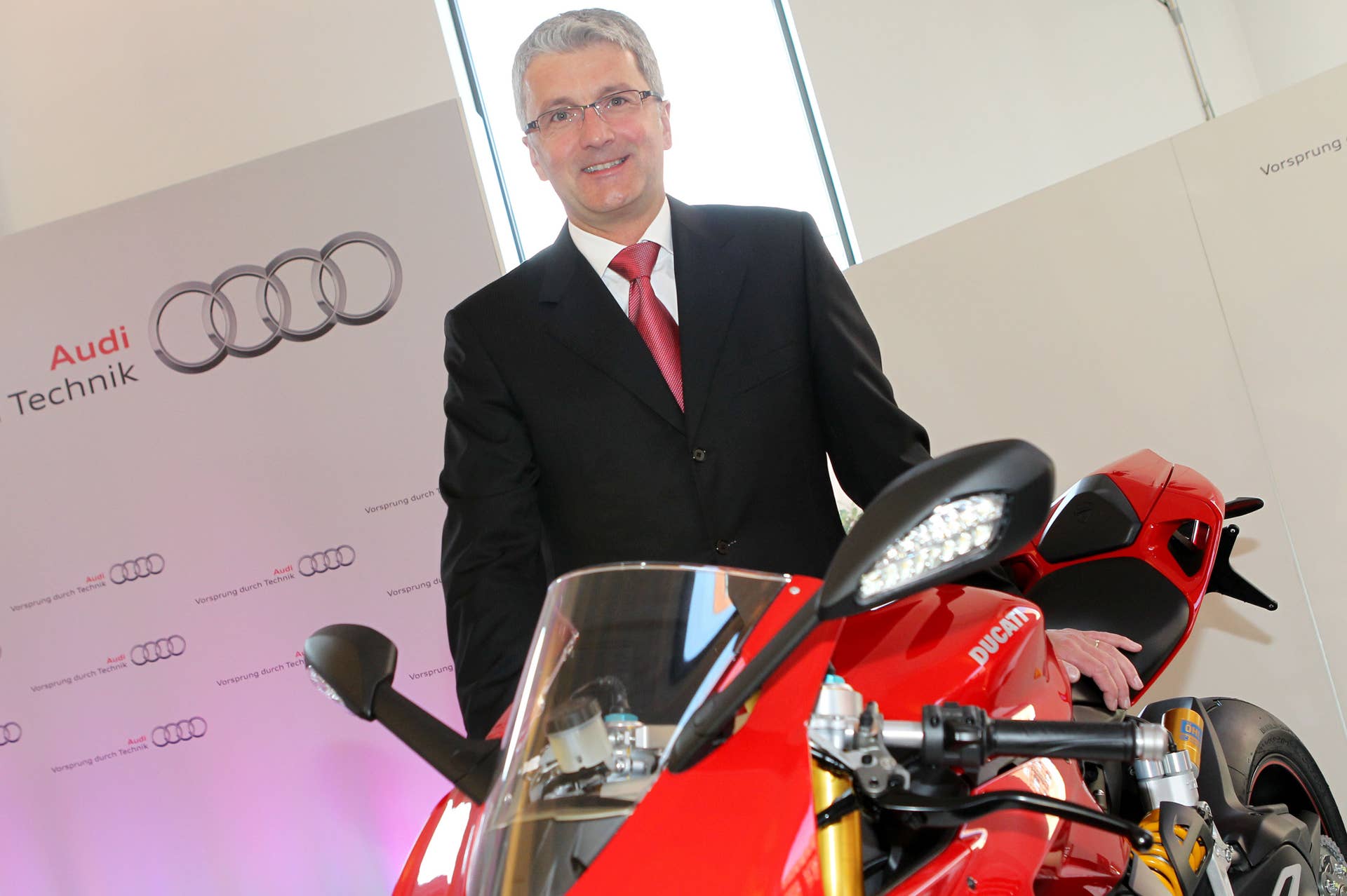 Rupert Stadler CEO of Germany upmarket auto firm Audi, owned by Volkswagen, poses next to a Ducati motocycle, on April 19, 2012 in Hamburg, during a press conference. Audi is to buy Ducati, the Italian maker of some of the most sought after high-speed motorcycles in the industry. 'The deal will be completed as soon as possible after it is cleared by the authorities,' Audi said in a statement on April 18, 2012. AFP PHOTO / MALTE CHRISTIANS +++ GERMANY OUT (Photo credit should read MALTE CHRISTIANS/AFP/Getty Images)