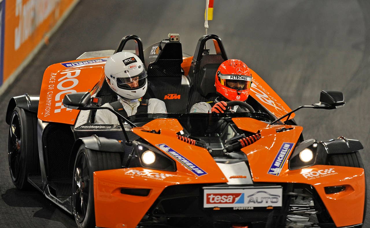 Germany's  F1 legend Michael Schumacher, right, races with soccer star Michael Ballack, left,  during the Race of Champions at the arena in Duesseldorf, western Germany, Sunday, Dec. 4, 2011.(AP Photo/Martin Meissner)