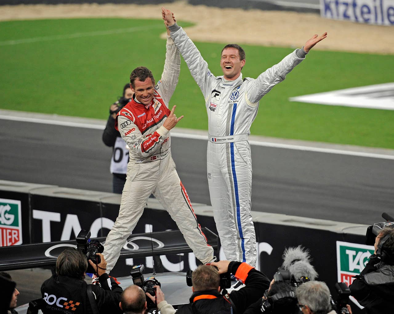 France's Sebastien Ogier, right, is celebrated by second placed Tom Kristensen of Denmark, left, after winning the final of the Race of Champions at the arena in Duesseldorf, western Germany, Sunday, Dec. 4, 2011. (AP Photo/Martin Meissner)