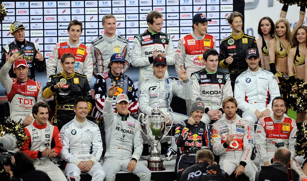 The drivers sit for a team picture prior the Race of Champions at the arena in Duesseldorf, western Germany, Sunday, Dec. 4, 2011. (AP Photo/Martin Meissner)
