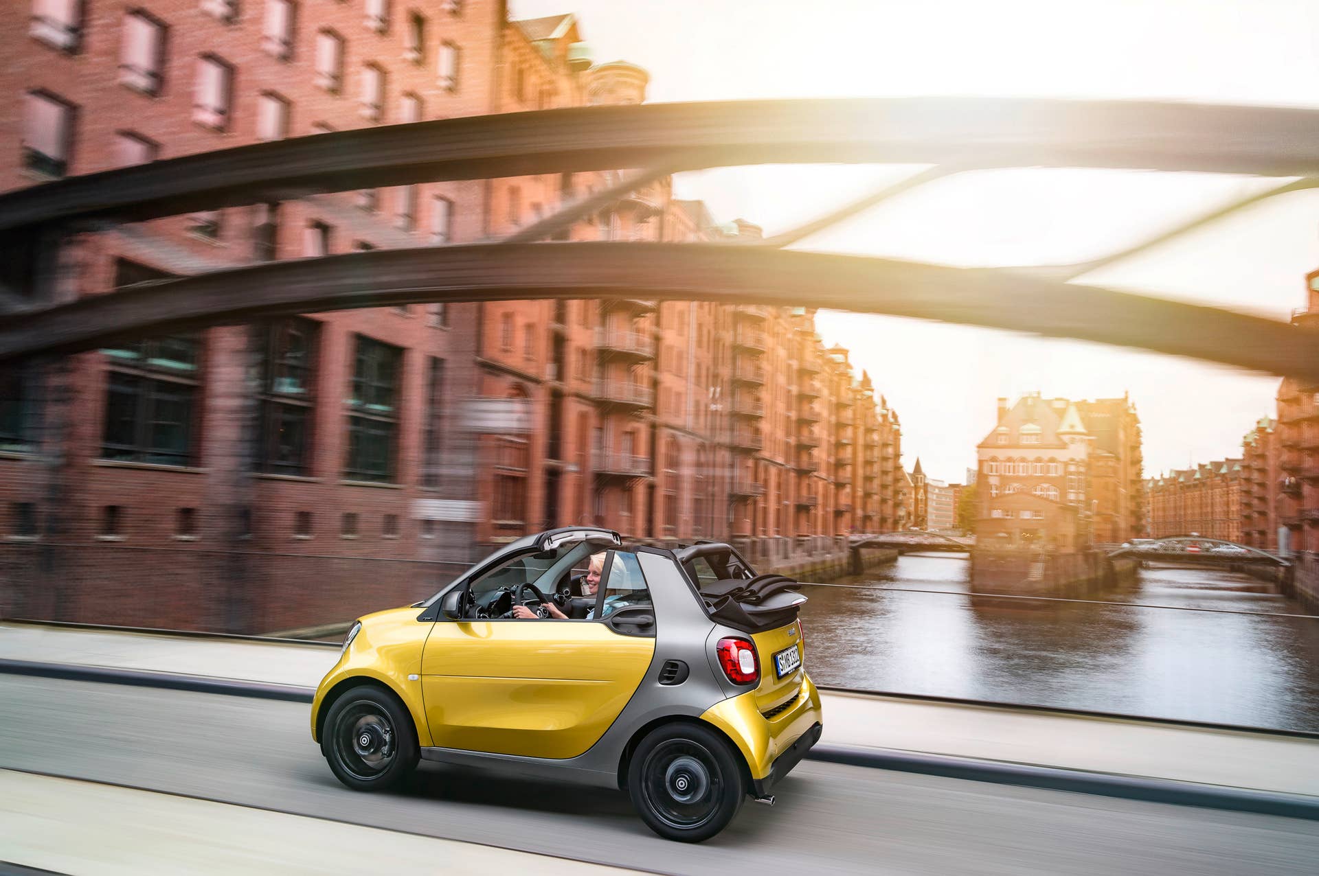 The 2016 Smart Fortwo Cabriolet, rear three-quarter crossing bridge.