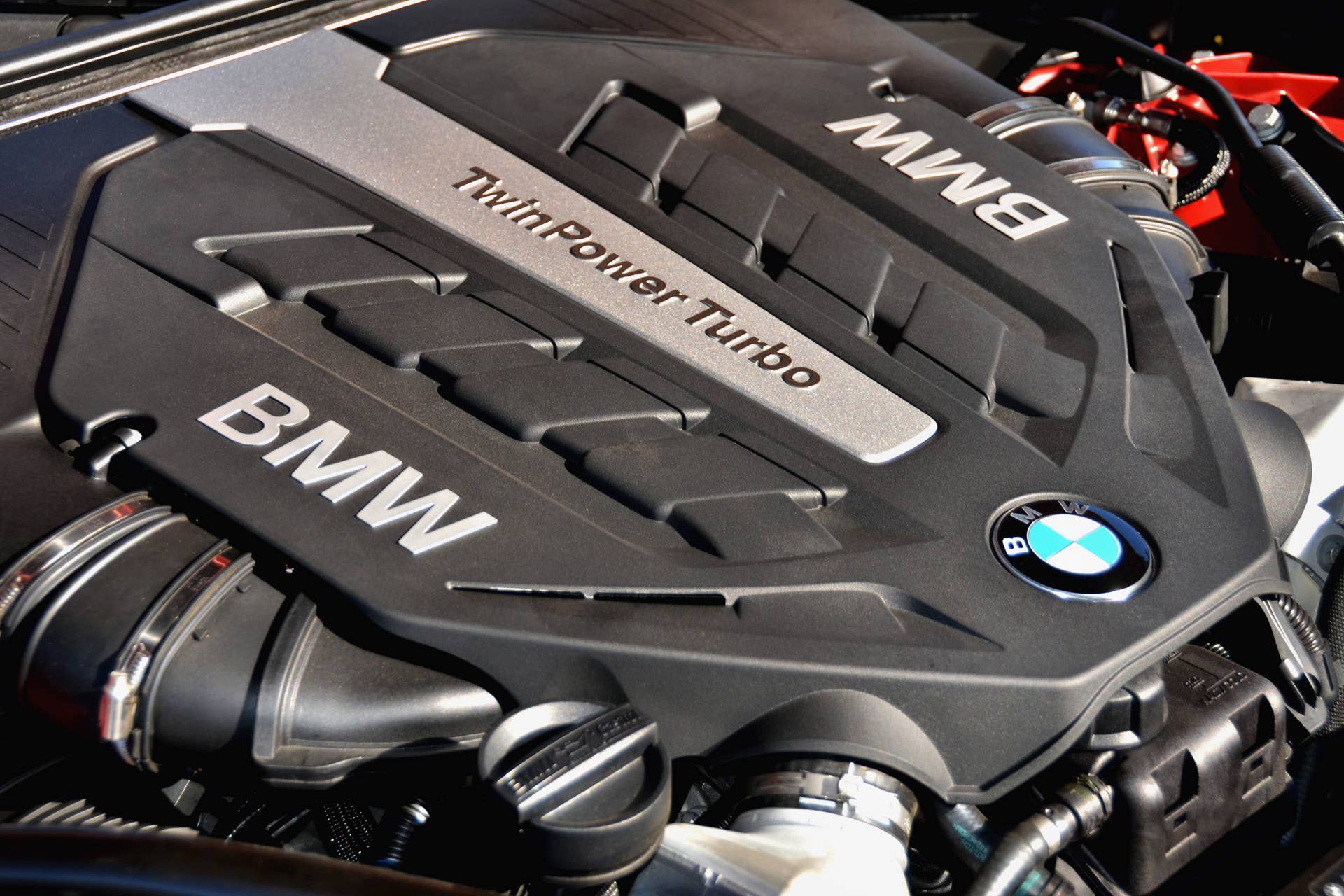 The 4.4 liter Twin Power Turbo V-8 engine with Bayerische Motoren Werke AG (BMW) logo, that powers the 2012 BMW 650i Coupe, is pictured in Carmel, California, U.S., on Monday, Aug. 22, 2011. The car has a $83,875 base price and features a direct injection engine that produces 400 horsepower and 450 pound-foot of torque. Photographer: Mark Elias/Bloomberg via Getty Images