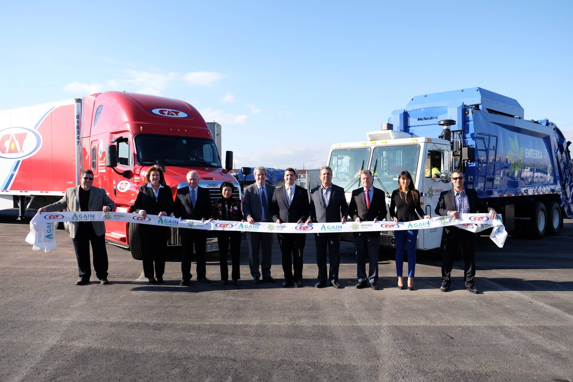 MISSISSAUGA, ON (October 26, 2015) - The first public compressed natural gas (CNG) fuelling station in Ontario opened today in Mississauga, Peel Region. In partnership among Emterra Group, GAIN Clean Fuel, C.A.T. Inc., the fuelling station will be available for heavy trucks operating in the Windsor to Montreal transportation corridor. Helping to cut the grand opening ribbon (left to right) Patrick Van Dehy, GAIN Clean Fuel; Mississauga Councillor Carolyn Parrish; Peel Region Chairman Frank Dale; Emterra Group Founder and CEO, Emmie Leung; Minister of Environment and Climate Change, Glen Murray; GAIN Business Development Manager, Marc-Andre Paquin; C.A.T. President, Daniel Goyette; Canadian Trucking Alliance CEO, David Bradley; VP of Corporate Strategy and Business Development, Paulina Leung; and Emterra General Manager Peel Division, Mike Rende. (Emterra Photo) (CNW Group/Emterra Group)