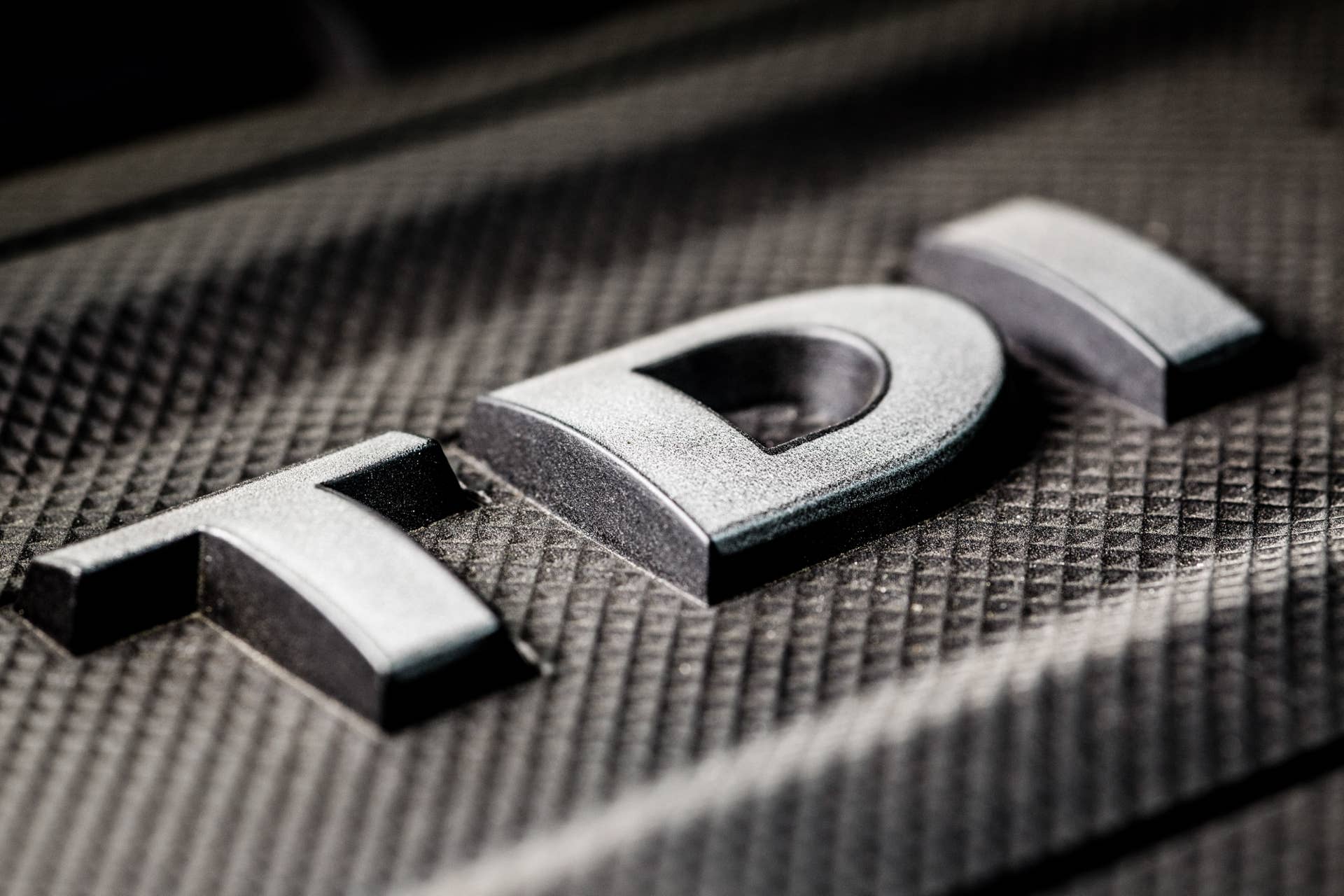 A TDI logo sits on the cover of the tubocharged direct injection diesel engine of a Volkswagen AG (VW) Passat TDI automobile in London, U.K., on Wednesday, Dec. 2, 2015. Volkswagen is grappling with an emissions scandal on three fronts: cheating software installed in about 11 million vehicles worldwide with 1.2-, 1.6- and 2.0-liter engines; irregular carbon dioxide ratings on about 800,000 vehicles in Europe; and questionable emissions software in about 85,000 VW, Audi and Porsche vehicles with 3.0-liter diesel engines in the U.S. Photographer: Miles Willis/Bloomberg via Getty Images