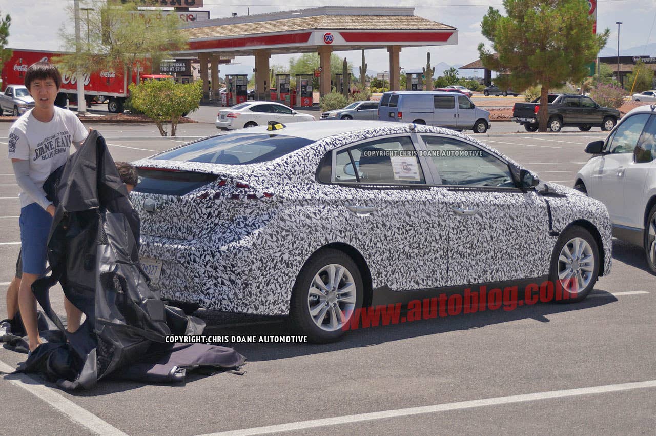 camouflaged hyundai prius-fighter spy shot covering