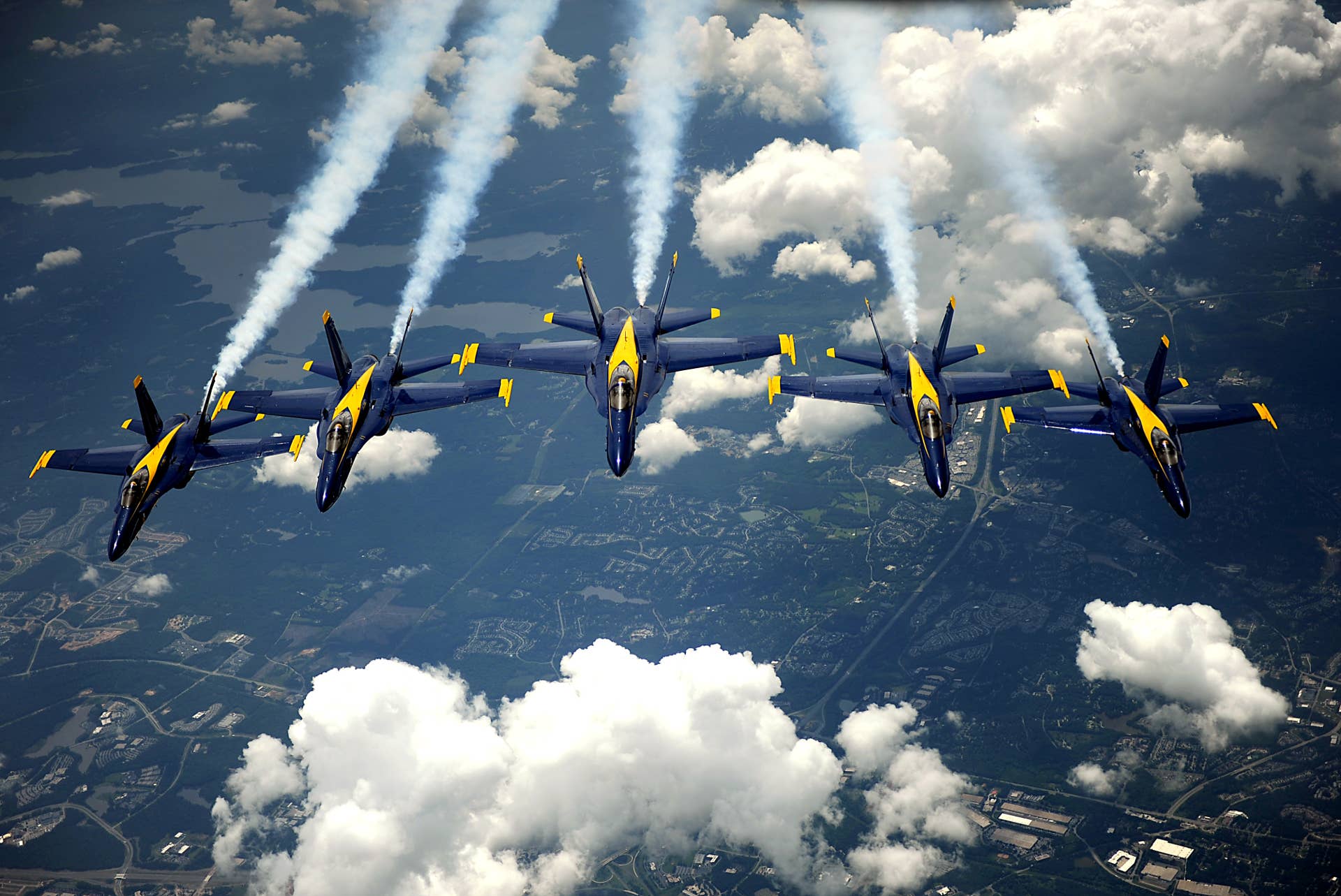 F/A-18 Hornet strike fighters assigned to the U.S. Navy flight demonstration squadron the Blue Angels pull into formation after being refueled from a KC-135 Stratotanker with the 756th Air Refueling Squadron, Joint Base Andrews Naval Air Facility, Md., May 16, 2012.